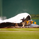 Illustration for article titled It Takes A Village To Secure An Infield Rain Tarp